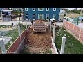 Dozer KOMATSU D20P startup project process fill land in the box house unload by dump trucks