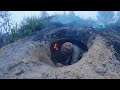 Camping alone building underground shelter in strong storm. Bushcraft. Camping in the rain
