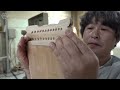 Process of making zither. Korean traditional musical string instruments factory
