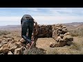 building  shelter with stones in the highest mountains to keep your hut warm Bushcraft shelter