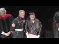 Marine Michael Burkhart surprises sister Kacy D. Watson with diploma.