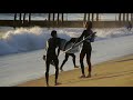 Surfers Attempt to Ride Waves Dangerously Close to the Beach on Tiny Surboards