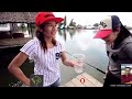 AMAZING to watch two tiny Thai girls wrestle with a giant catfish. Lake fishing in Thailand.