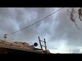 Our family jumps into action to cover our exposed roof just after roofer peels off old tiles