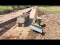 25-ton truck valiantly unloads soil at perilous road while incredible bulldozer push road connection