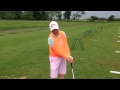 Junior golfer practicing on the range with the Golf Swing Shirt..then he gives his feedback !