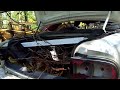 loading a shot up buick onto a trailer to haul to scrap yard