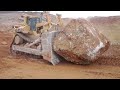 Caterpillar D11R pushing another massive rock