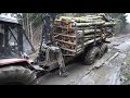 Belarus Mtz 1221.2 with big homemade trailer logging in winter forest, slippery conditions