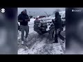 Buffalo Bills players dig out cars buried in snow