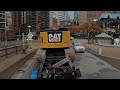 Large excavator transported through Manhattan. Cat 335 navigating traffic on a lowboy