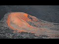 Lava flows out of a hole on the side of the crater of volcano Fagradalsfjall Iceland , 10 July 2021