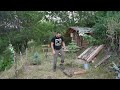 The man built a well near the log cabins in the forest. Bushcraft
