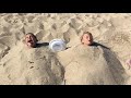 Hope and Luke buried in sand