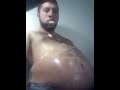 Man with big gut eats a roasted chicken
