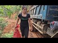 the driver and the girl driving a car carrying wood on the mountain.