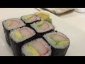 A sushi chef's demonstration of the technique for making a California roll