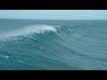aerial shot of surfer riding wave