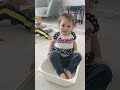 bebek oyuncak kutusunun içine girmeye çalışıyor