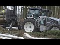 Logging in winter forest with Valtra A124 forestry tractor