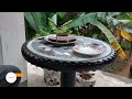 Making a coffee table out of old tires and tiles is a simple task.
