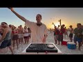 playing house music on the beach until people dance