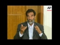 WRAP Defiant Saddam Hussein appears in court for first time