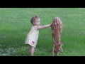 Little Girl Plays with Fawn