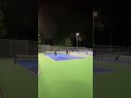 Pickleball players playing ball on a cold winter evening