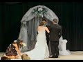 Bride shocks groom as she sings to him walking down the aisle. 