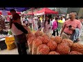 Urban Market in Guizhou, China: Bustling, Sea of Roasted Seeds, Spicy Goods Haven, Diligent Vendors