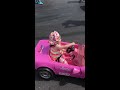 little girl doing burnouts in toy car