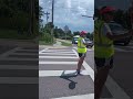 The crossing guard had to crane and look around a car to see if a pedestrian was approaching.