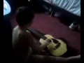 4yr old non verbal autistic son attempting to play the guitar