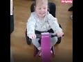 Little girl with spina bifida surprised with adaptive tricycle