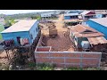 Team Dump truck wheel 10 unloading soil in Home Foundation pushing by bulldozer komat'su D31