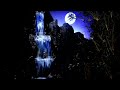 The moon sits relaxed on the hill lighting up the waterfall at night so it's bright